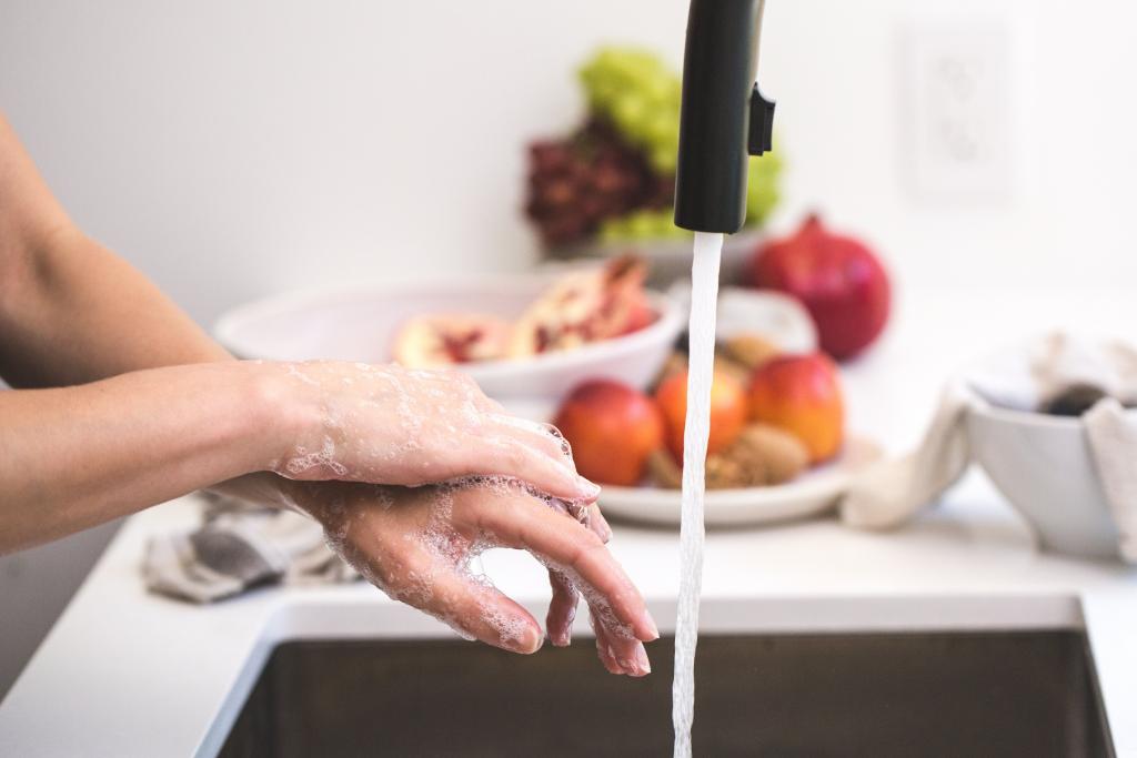 photo of person washing hands
